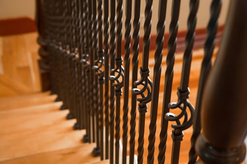 Iron balusters with a twisted basket design on staircase